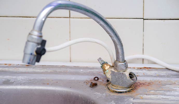 A faucet severe damaged by hard-water mineral calcification