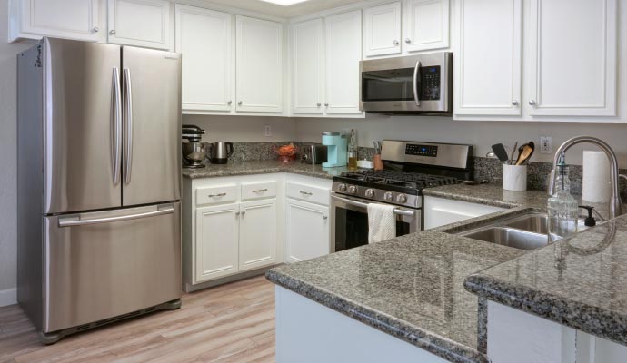 Modern kitchen with cabinets Modern kitchen with white cabinets, granite countertops, and stainless steel appliances