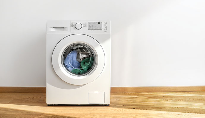 Modern washing machine with clothes inside