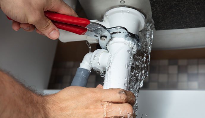 Fixing loose pipe connection under sink