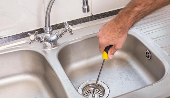 Person repairing a leaky dishwasher