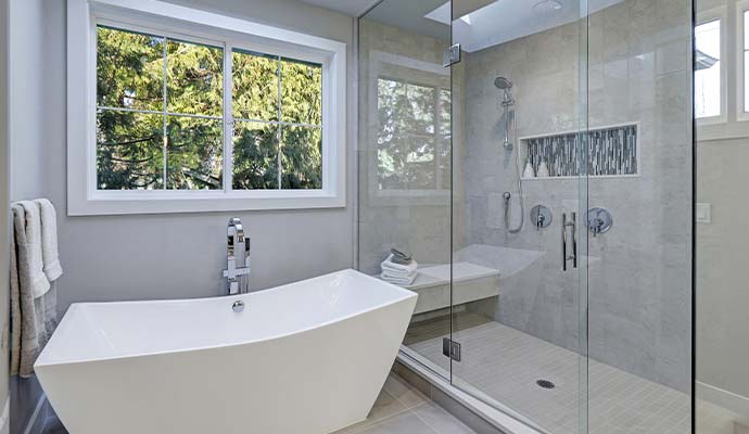 Modern bathroom with bathtub and glass shower