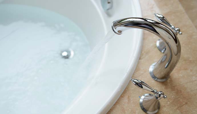 Modern faucet in bathtub