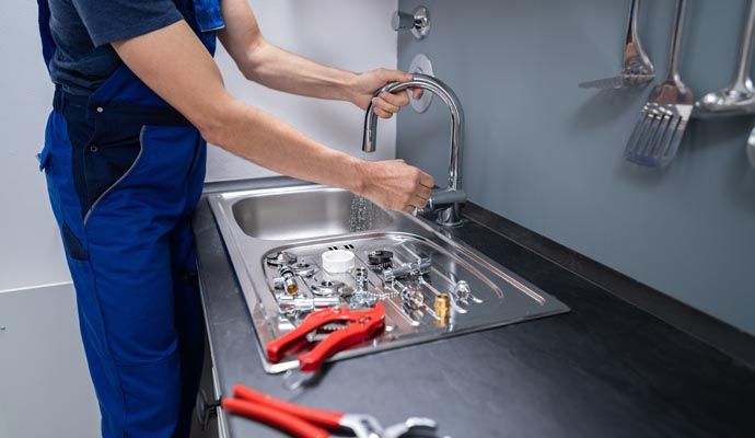Person repairing sink
