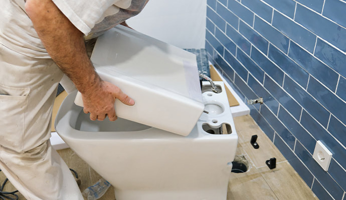 Technician repairing running toilet
