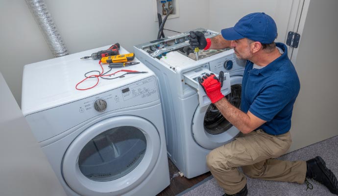 Technician repairing washing machine