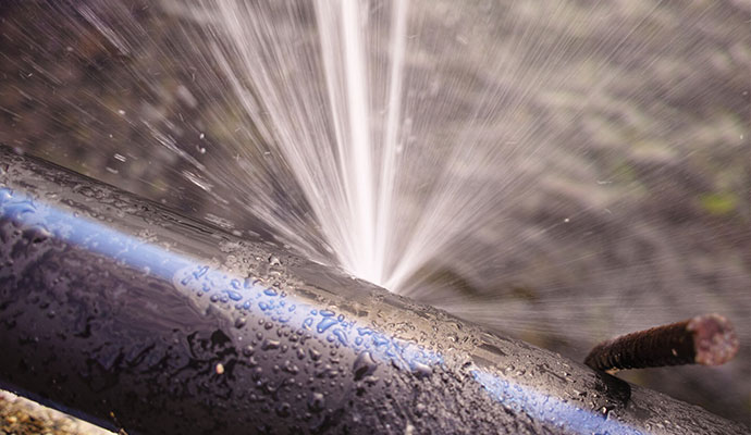 Water spraying from burst pipe