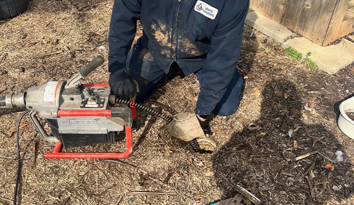 Professional plumber performing sewer line maintenance