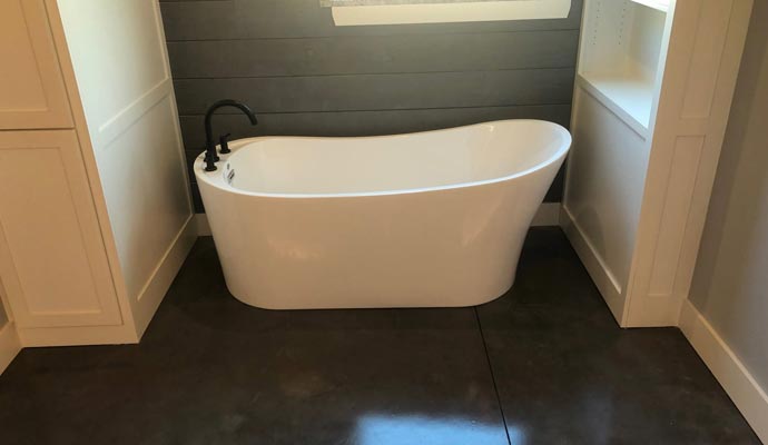 White freestanding tub with black faucet