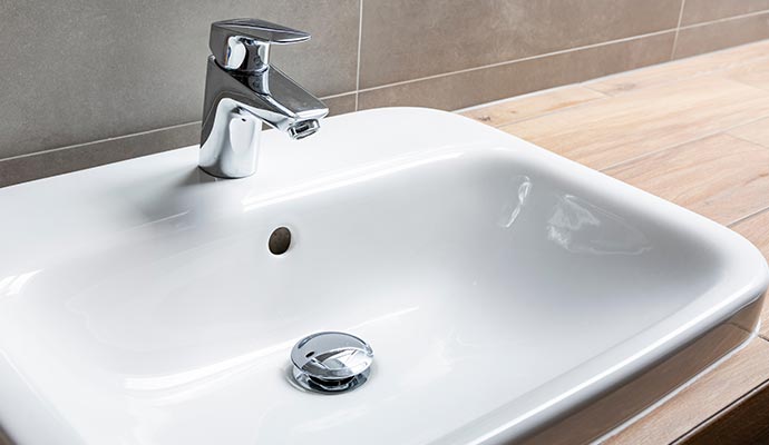 White rectangular bathroom sink with faucet